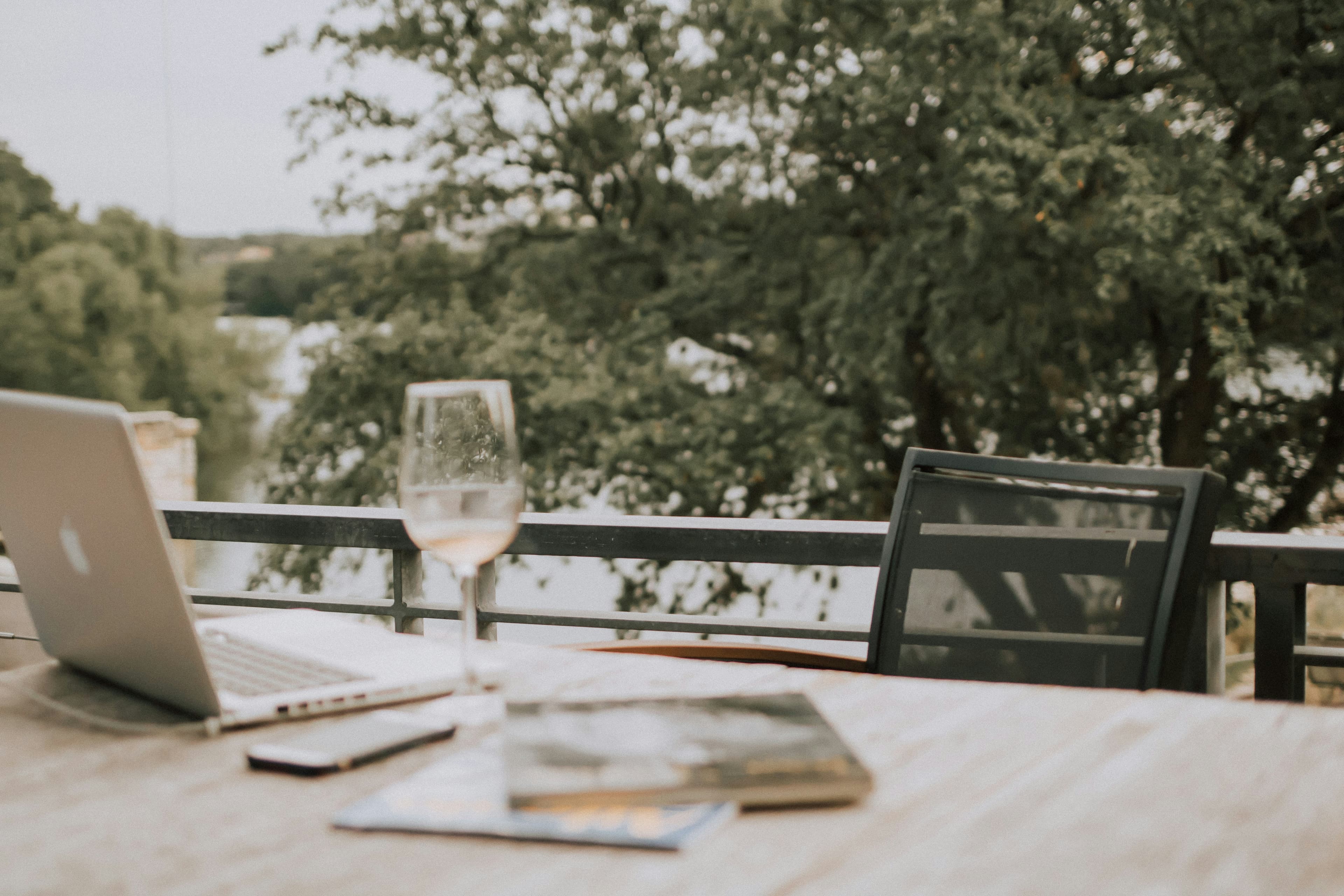 Laptop and wine bottle — the early-morning prep setup every wine rep knows